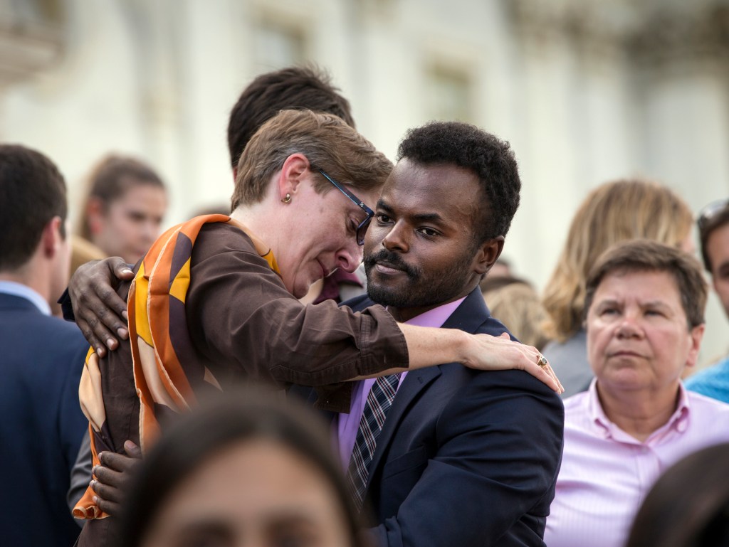 People comfort each other as members of the LGBT Congressional Staff Association and the Congressional Muslim Staff Association gather for a prayer and moment of silence on the steps of the Capitol to stand in solidarity with the Orlando community. Photo: J. Scott Applewhite, AP.