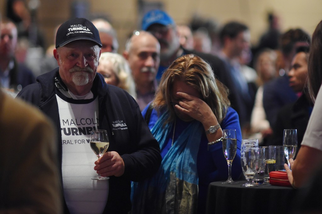 FACEPALM: Liberal party members react as they watch Opposition Leader Bill Shorten on a screen at the Liberal party election night event at the Sofitel Wentworth hotel in Sydney. Photo: Lukas Coch, AAP.