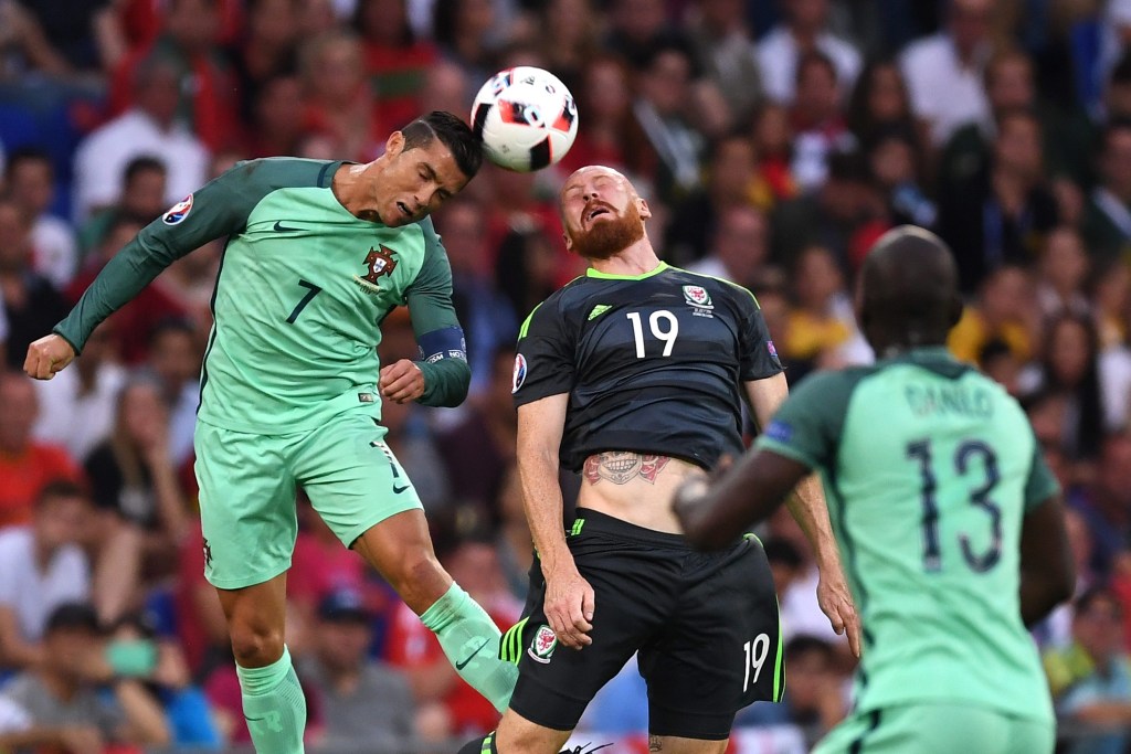 Cristiano Ronaldo in action against James Collins of Wales. Photo: GEORGI LICOVSKI, EPA.