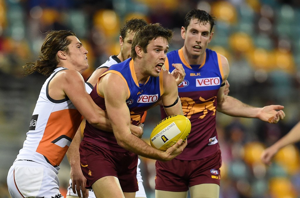 Lion Ryan Bastinac is tackled by GWS co-captain Phil Davis. Photo: Dan Peled, AAP.