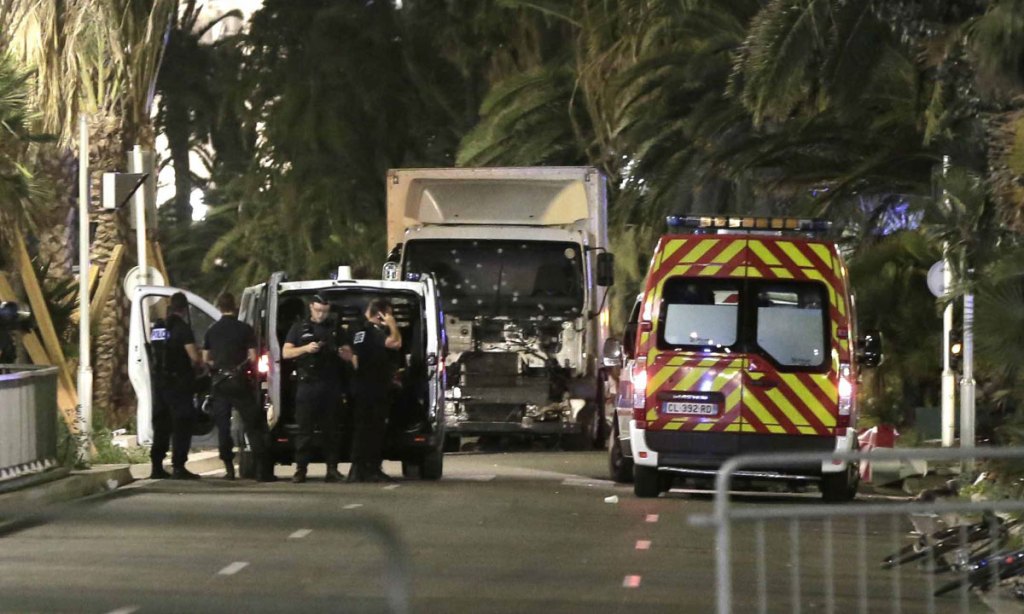 Police officers stand guard near the truck after it crashed into the crowd during the Bastille Day celebrations in Nice. Photo: EPA