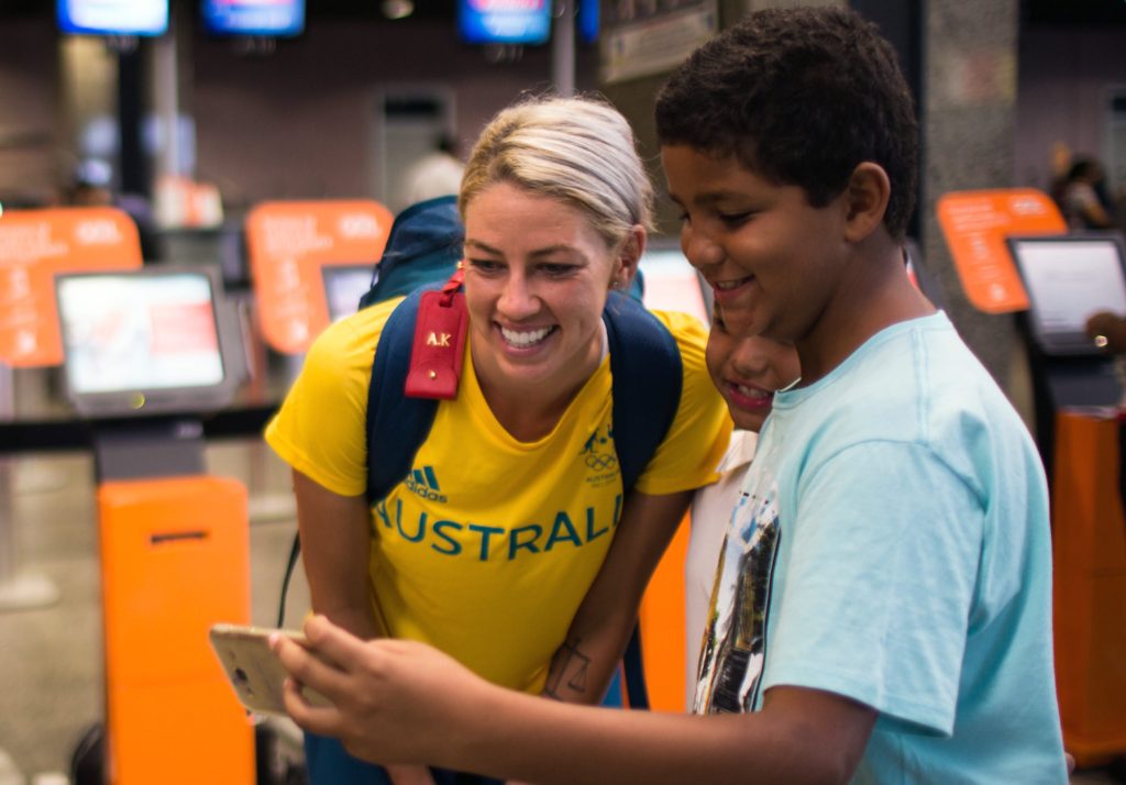Matildas player Alanna Kenney poses for a photograph with a local at the airport in Fortaleza, Brazil ahead of the Olympics. Photo: AAP/Supplied.