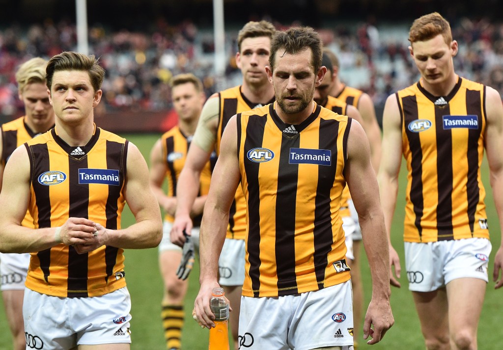 Luke Hodge leads his teammates from the field after an unexpected loss to the Demons. Photo: Julian Smith, AAP.