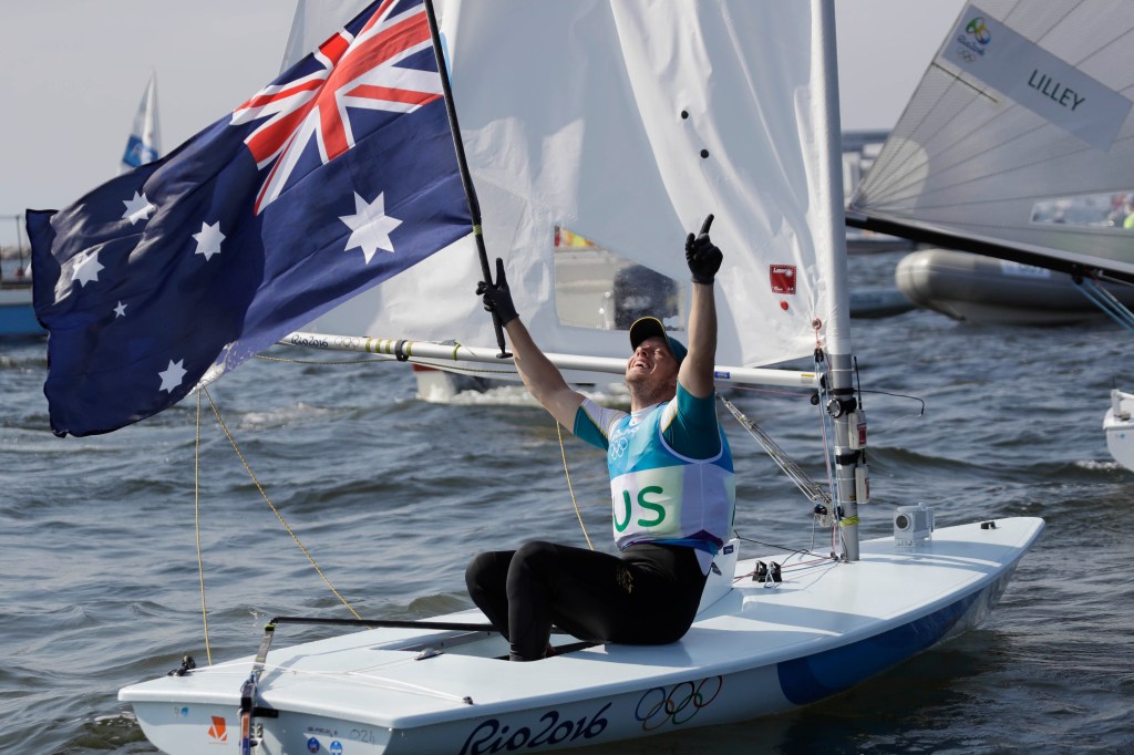 Australia's Tom Burton celebrates after winning the Laser men gold medal. Photo: Gregorio Borgia, AP.
