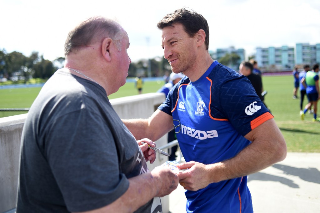 Brent Harvey signs autographs during training after North Melbourne announced his contract would not be renewed. Photo: Tracey Nearmy / AAP
