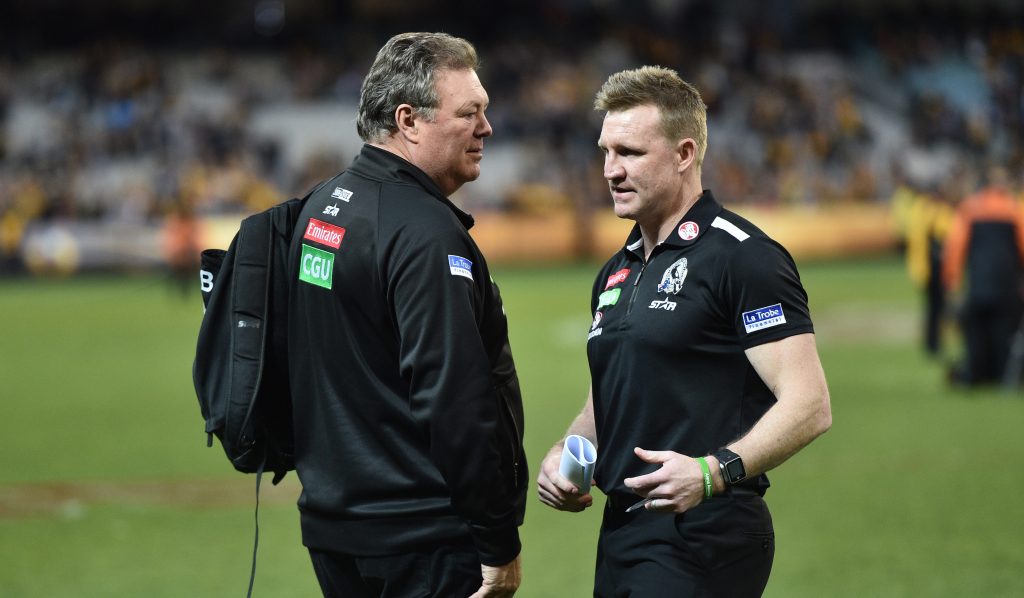 Collingwood Head of Football Neil Balme speaks with coach Nathan Buckley after yesterday's loss to Hawthorn. Photo: Julian Smith / AAP