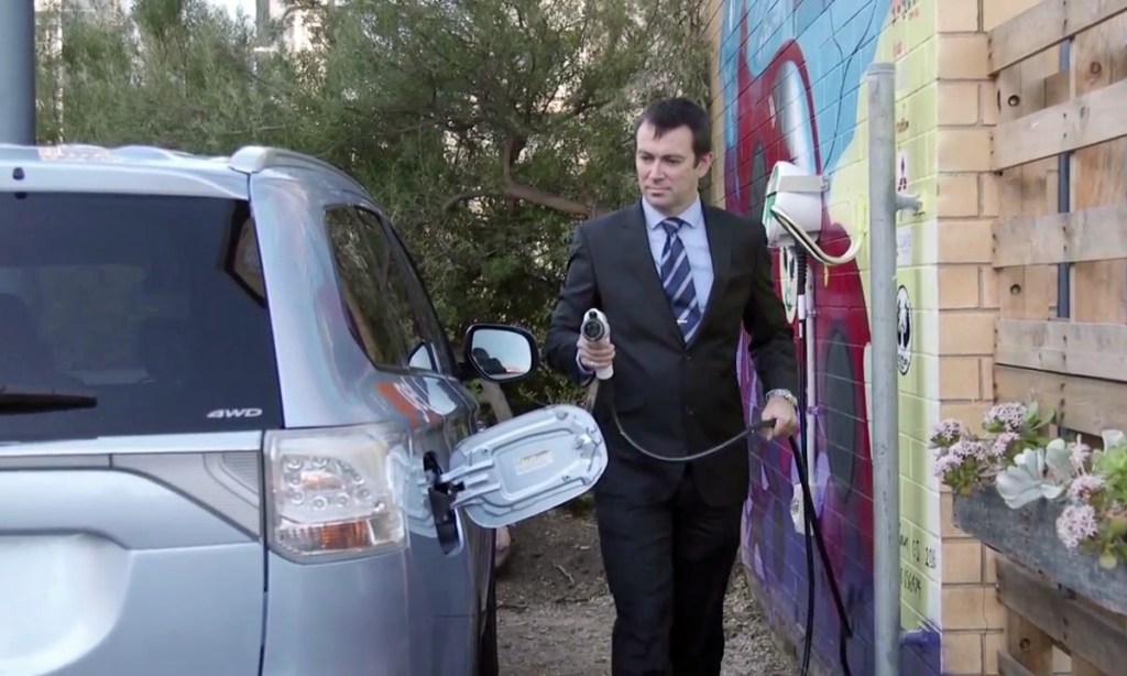 Engineer Michael Smyth, about to plug in and charge up an electric four-wheel drive. Image: supplied.