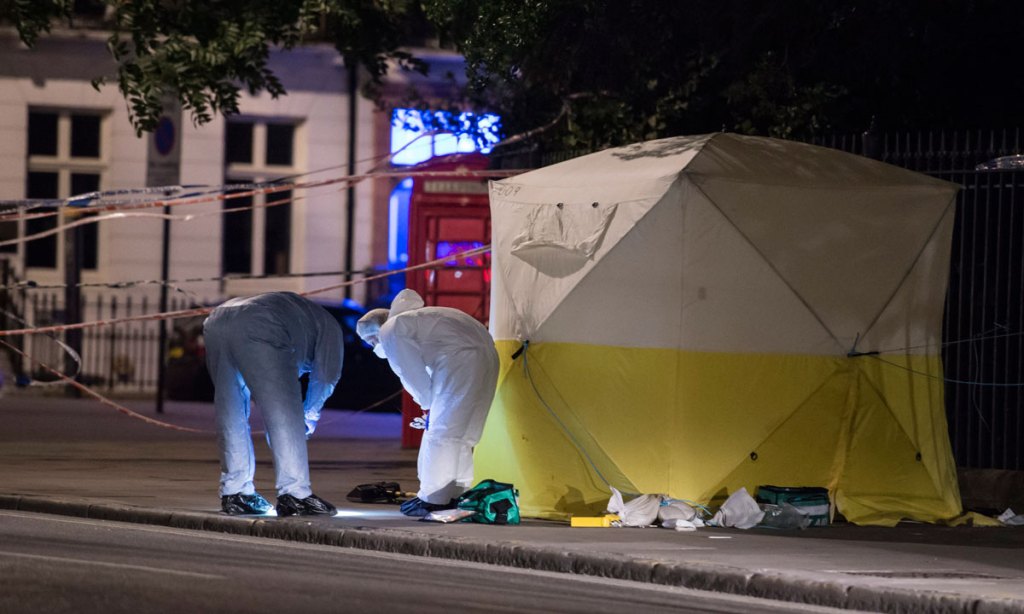 Police search the scene of the London attack. Photo: EPA