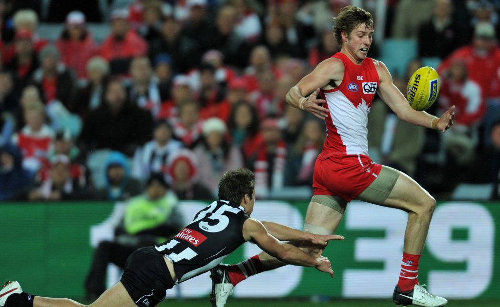 Alex Johnson juggles the ball ahead of Collingwoods Jamie Elliott - whose season has also been wiped out by injury - in 2012. It was the last year he took the field. Photo: Paul Miller / AAP