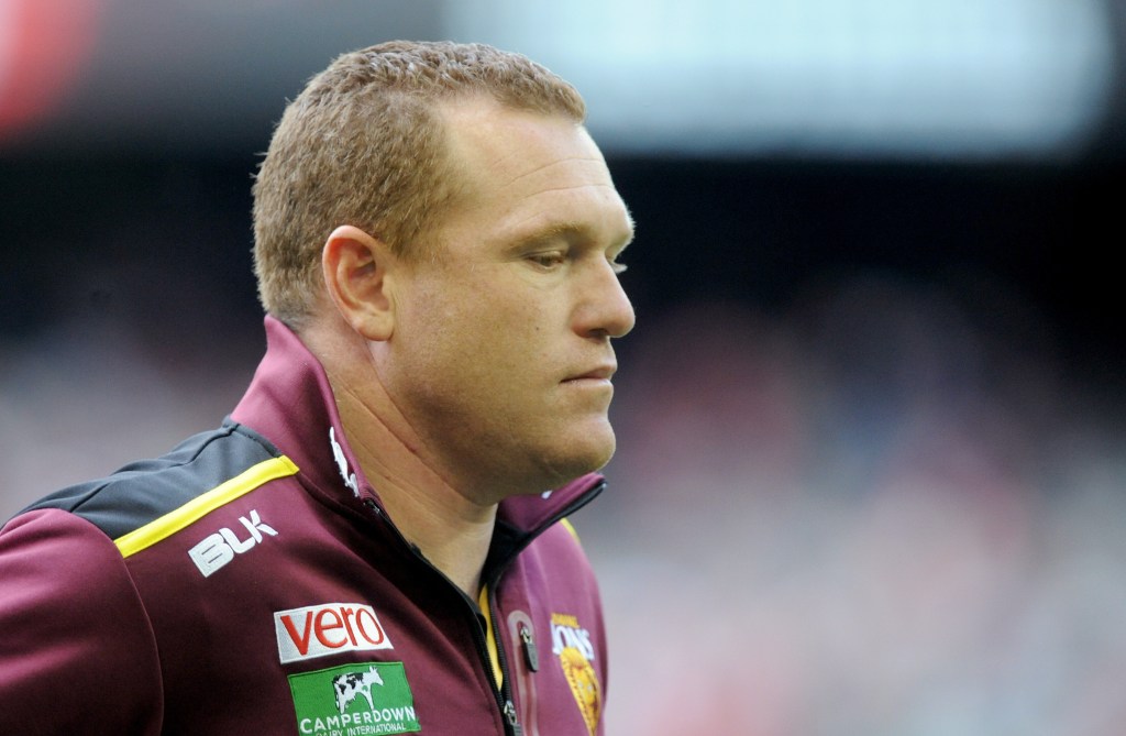 A disappointed Justin Leppitsch walks off the ground in his final game as Brisbane coach. Photo: Joe Castro / AAP