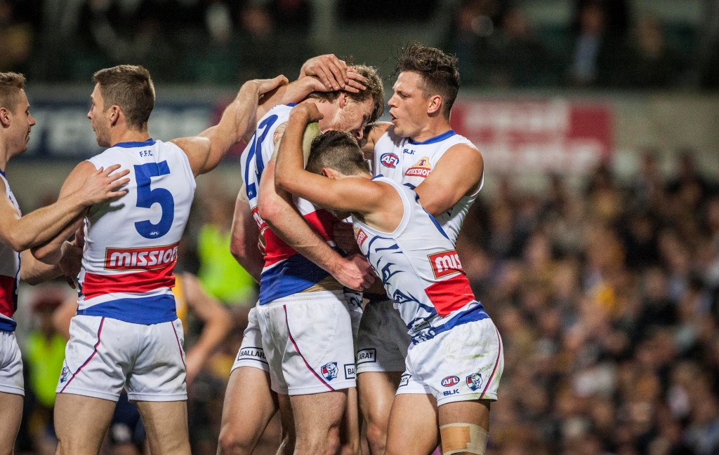 Bulldogs players celebrate a goal. Photo: Tony McDonough / AAP