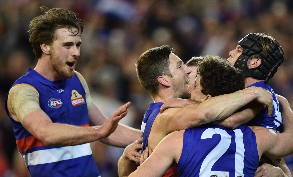 Bulldogs players react after knocking off triple premiers Hawthorn. Photo: Julian Smith / AAP