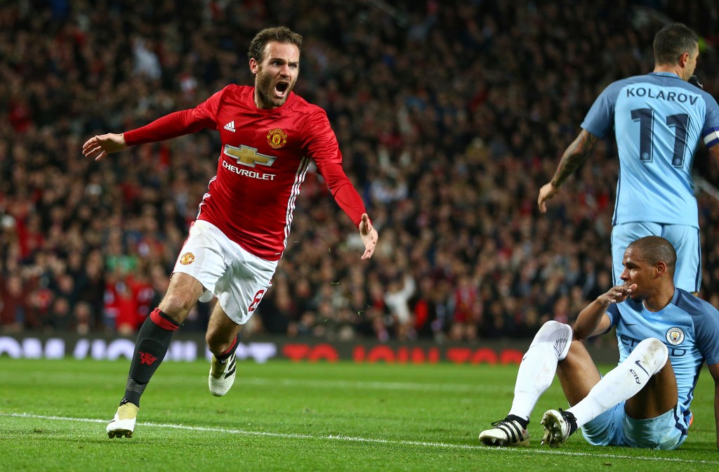 Manchester United's Juan Mata celebrates scoring a goal against crosstown rivals Manchester City at Old Trafford. Photo: Dave Thompson / AP