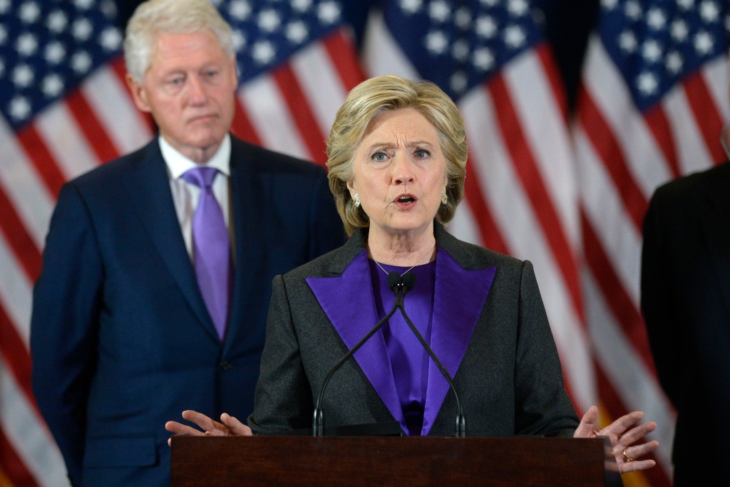 Hillary Clinton concedes the election with husband and former president Bill looking on. Photo: Olivier Douliery/Abaca