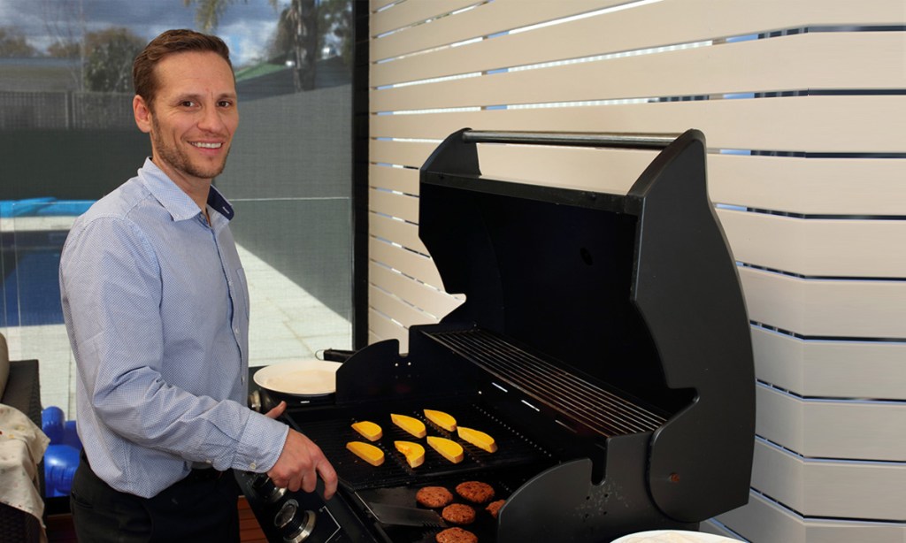Alex McConville fires up the barbie for his veggie bean burgers.