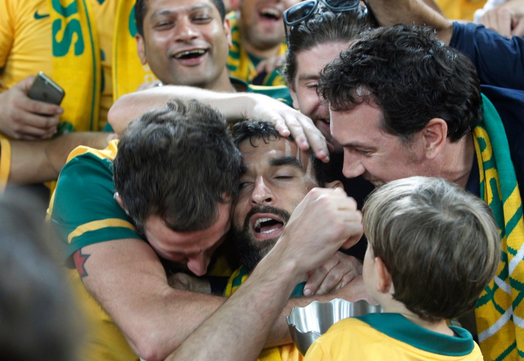 Mile Jedinak celebrates with fans after his Socceroos won the 2015 AFC Asian Cup - a success for Australia both on and off the field. Photo: Quentin Jones / AP