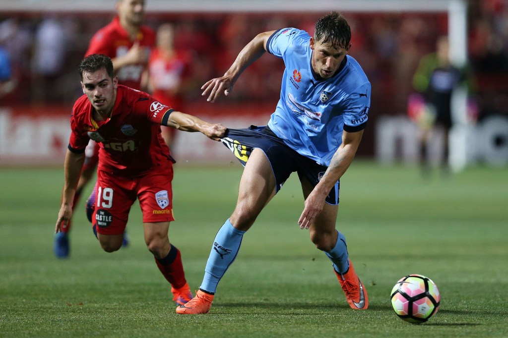 Ben Garuccio of United tries to catch Sydney's Filip Holosko during their clash in Adelaide last month. Photo: James Elsby / AAP