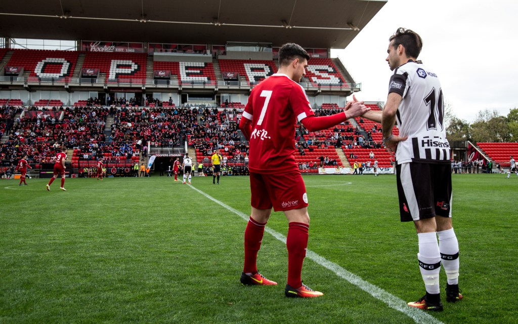 Campbelltown City’s Luigi Di Troia and Adelaide City’s Nikola Mileusnic (now with Adelaide United) shake hands before last year’s grand final. Photo: Supplied.