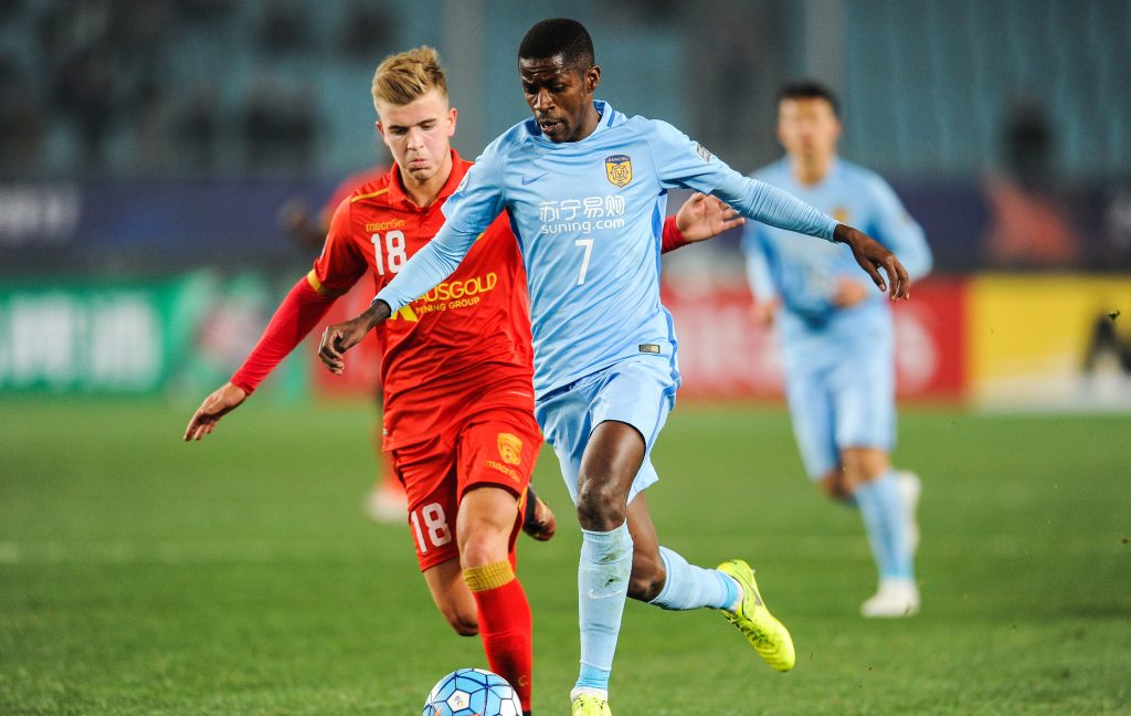 Potential Socceroos debutant Riley McGree garners some attention from Brazilian Ramires of China's Jiangsu Suning FC while playing for Adelaide United in the AFC Champions League earlier this month. Photo via AAP