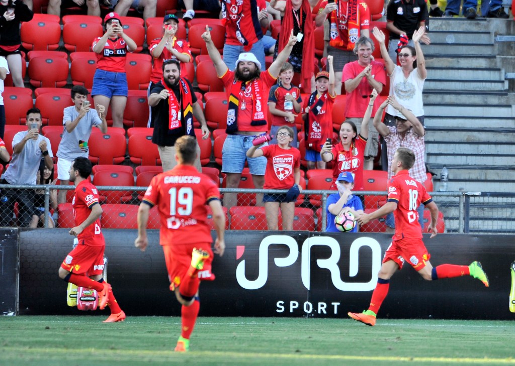 Adelaide players celebrate the late penalty that put them in front. Photo: David Mariuz / AAP