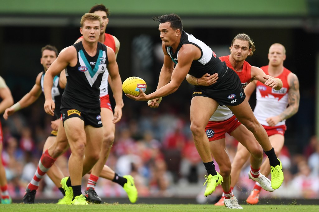 Sam Powell-Pepper gets a handball away despite pressure from Jordan Foote. Photo: Dean Lewins / AAP
