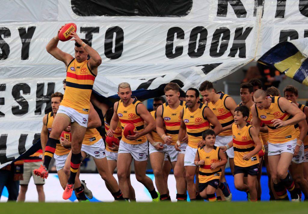 Taylor Walker leads the Crows out for the first quarter against North Melbourne. Photo: Rob Blakers / AAP