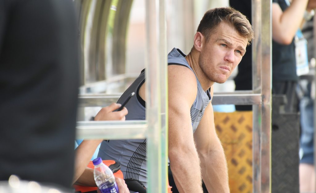 Robbie Gray sits on the bench after having has his ankle strapped during training at Jiangwan Stadium. Photo: Tracey Nearmy / AAP