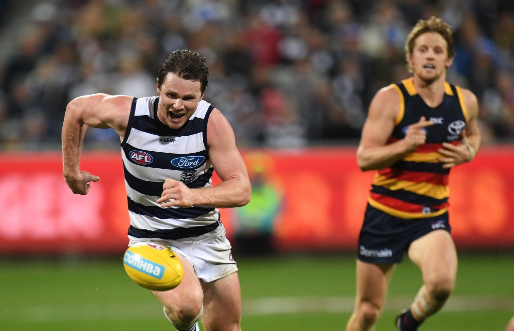 Patrick Dangerfield appears highly amused as he beats his old mate Rory Sloane to the ball. Photo: Julian Smith / AAP