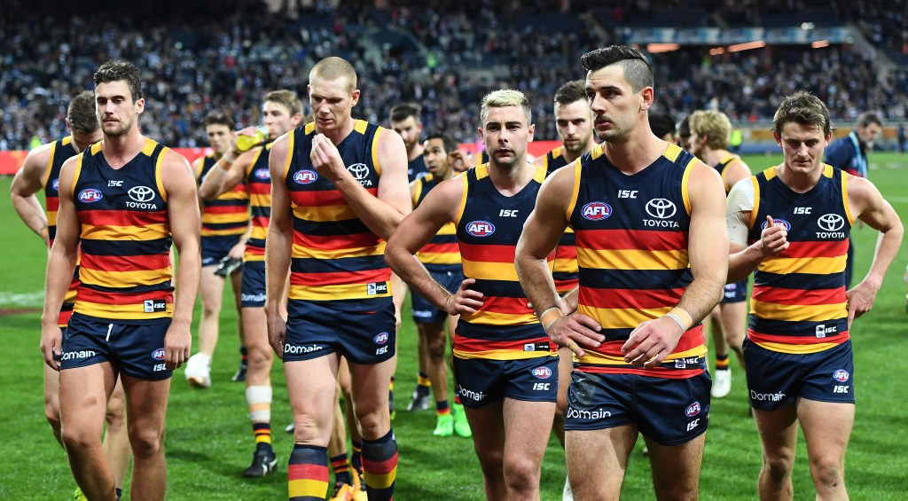 Walker leads the Crows from the field after their loss to Geelong. Photo: Julian Smith / AAP