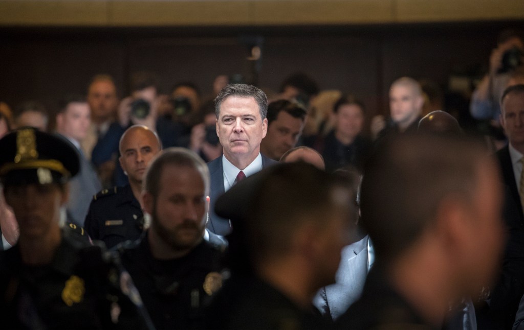 Former FBI director James Comey walks through a corridor on the way to a secure room to continue his testimony. Photo: AP/J. Scott Applewhite)