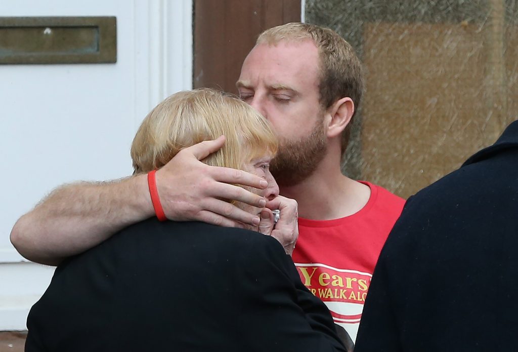 Family members of Hillsborough victims embrace after a meeting with Crown Prosecution Service chief Sue Hemming, who announced criminal charges would be laid. NIGEL RODDIS / EPA