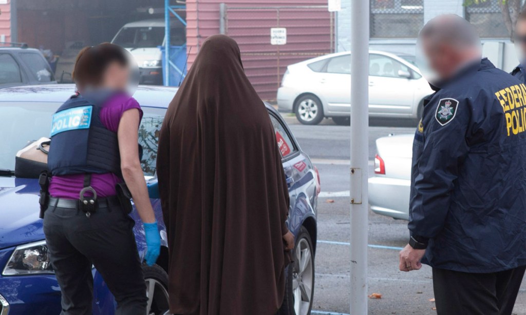 Police making an arrest of an Adelaide woman late last month. She was charged with being a member of the Islamic State terror group. Her lawyers have reportedly indicated she will deny the charge. Photo: AAP