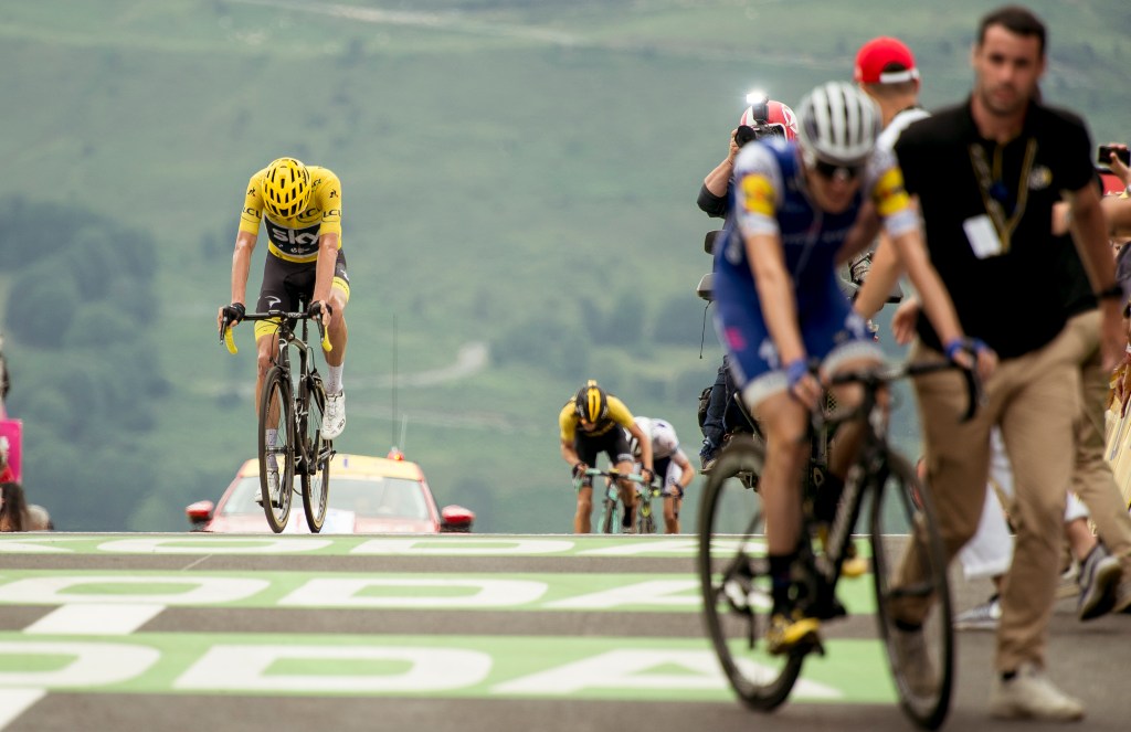 Chris Froome loses his lead overall as he crosses the finish line, with Dan Martin in the foreground at the summit of the Peyragudes. Photo via AAP