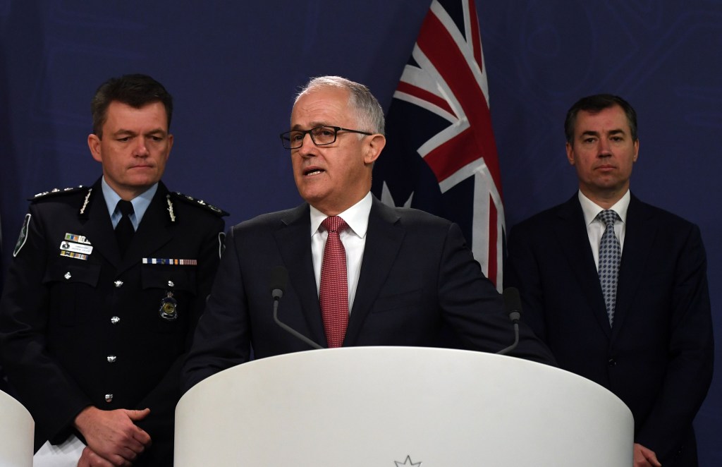 Prime Minister Malcolm Turnbull alongside AFP Commissioner Andrew Colvin (left) and Minister for Justice Michael Keenan (right) on Sunday. Photo: AAP/Sam Mooy