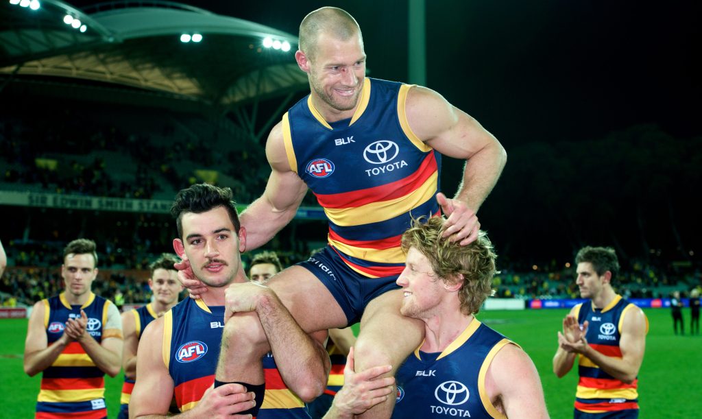 Scott Thompson chaired off Adelaide Oval by Taylor Walker and Rory Sloane after his 300th game last year. Photo: Michael Errey / InDaily