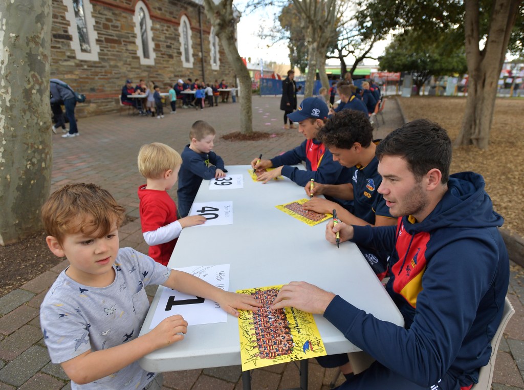Mitch McGovern signs autographs at Goodwood Primary School this week. Photo: David Mariuz / AAP