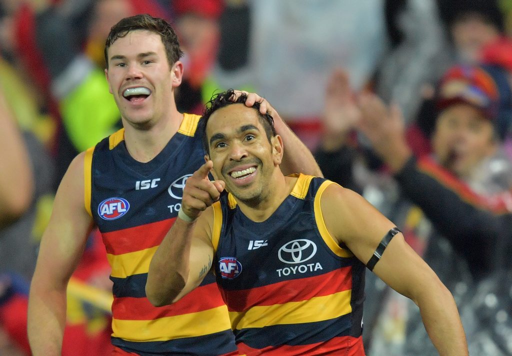 Mitch McGovern congratulates Eddie Betts on a goal against the Power. Photo: David Mariuz / AAP