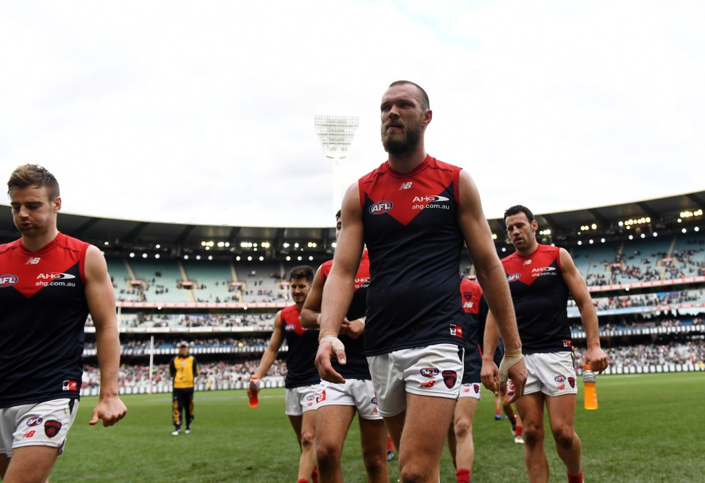 Demons players trudge off the MCG after their loss to Collingwood. Photo: Tracey Nearmy / AAP
