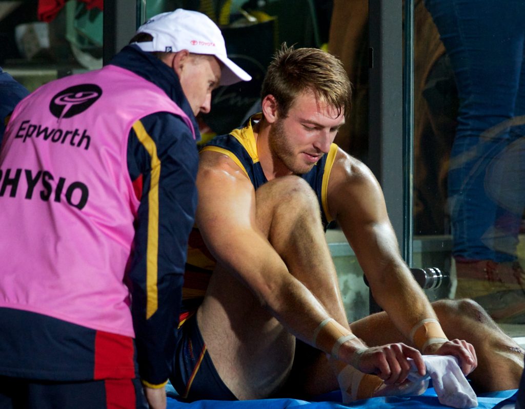 Daniel Talia receives attention on the bench on Friday night. Photo: Michael Errey / InDaily