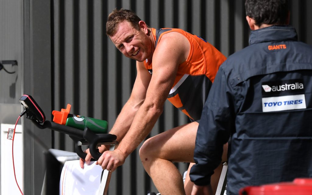 Steve Johnson warms up on a bike during a team training session this week. Photo: David Moir / AAP