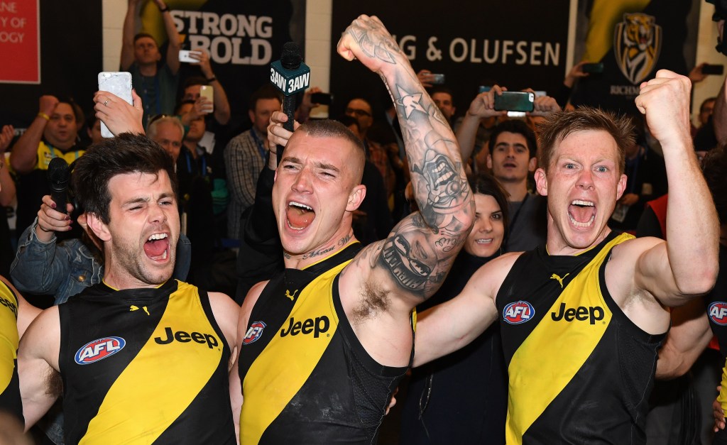 Dustin Martin celebrates Saturday's preliminary final win with Trent Cotchin and Jack Riewoldt. Photo: Julian Smith / AAP