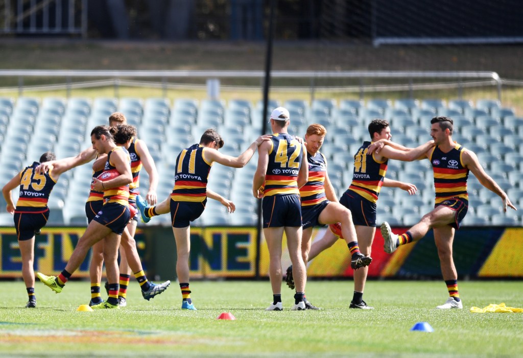 Mitch McGovern (right, with Taylor Walker) joins Crows teammates at this morning's training session. Photo: Tracey Nearmy / AAP