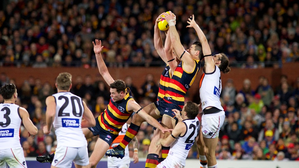 GWS players watch as Taylor Walker and Sam Jacobs vie for the ball. Photo: Michael Errey / InDaily