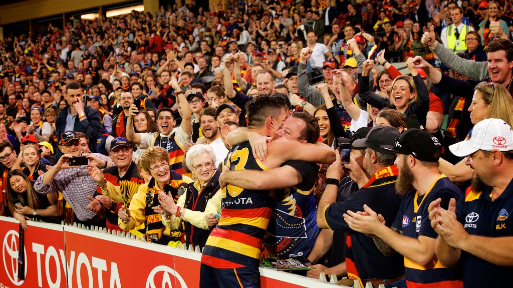 Tex Walker shares an embrace with a long-suffering supporter after the siren. Photo: Michael Errey / InDaily