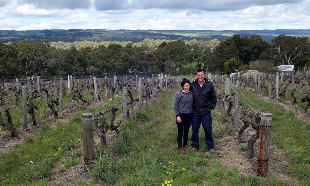 Lisa and Mark McCarthy among the vines on McCarthy's Orchard. Photo: Philip White