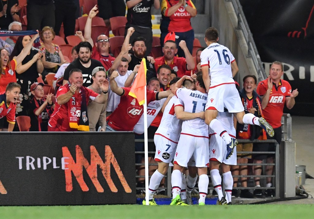 Adelaide United players and supporters celebrate Ryan Kitto's goal against Brisbane Roar. Photo: Darren England / AAP