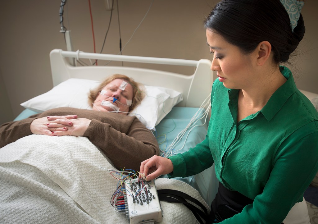 Dr Ching Li Chai-Coetzer, from the Adelaide Institute for Sleep Health, testing a patient for sleep apnoea. The new Flinders Centre of Research Excellence is looking for more simplified sleep study testing.