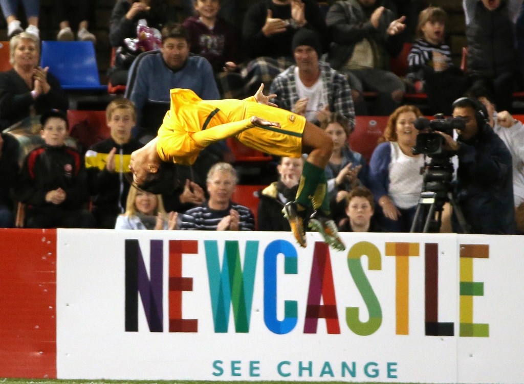 Australia's Sam Kerr does her trademark backflip to celebrate scoring against Brazil during their September friendly in Newcastle. Photo: Rick Rycroft / AP