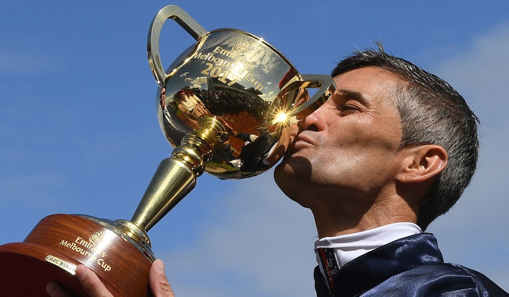 Corey Brown kisses the Melbourne Cup after Rekindling won the Melbourne Cup at Flemington Racecourse today. Photo: Julian Smith / AAP