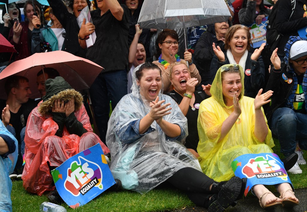 Supporters of marriage equality celebrate in Hindmarsh Square today as the winning "yes" vote is announced. Photo: AAP/David Mariuz